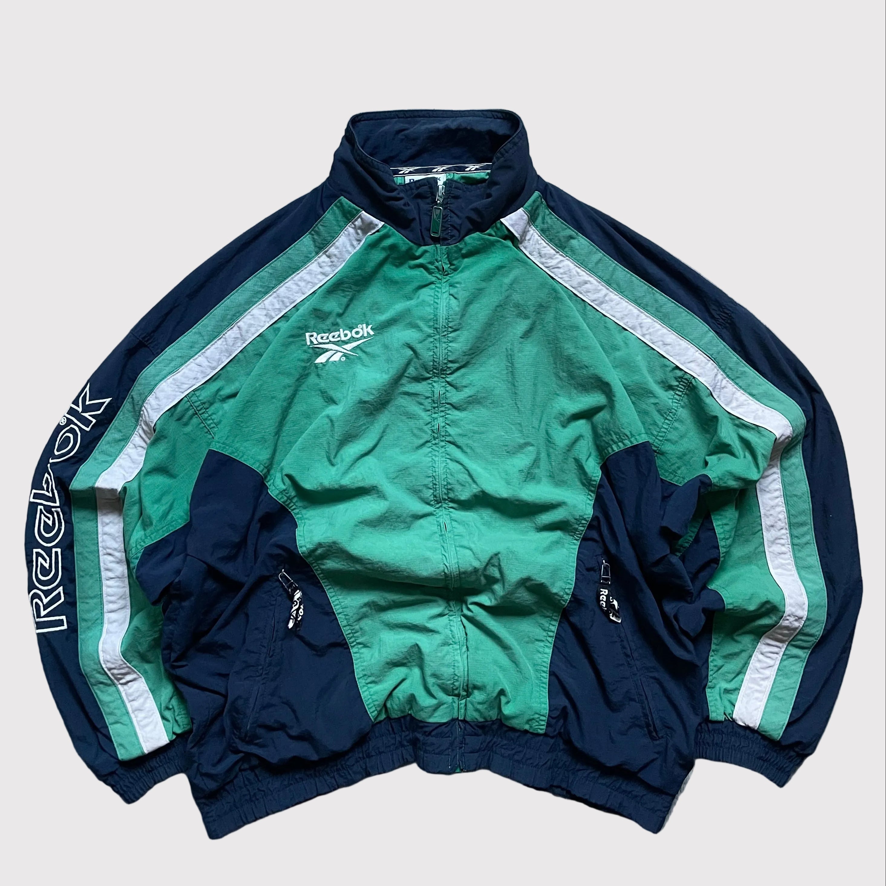 Vintage green Reebok windbreaker with a lightweight, retro athletic design and classic logo detailing
